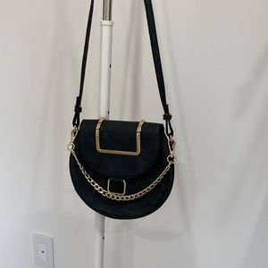 Black shoulder purse with gold detailing and chain